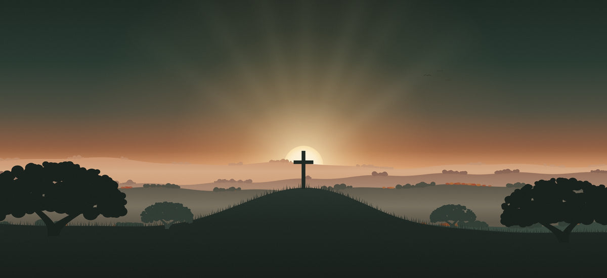 Sunrise over the Texas Hill Country with a cross on a hill and live oak trees